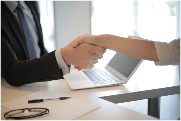 an investor shaking a rental property lender’s hand