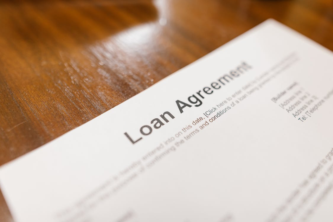 A Loan Agreement Document for a Fix and Flip Loan Lying on a Wooden Table