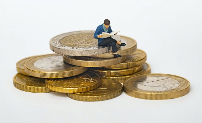 a man sitting on coins indicating a successful investment