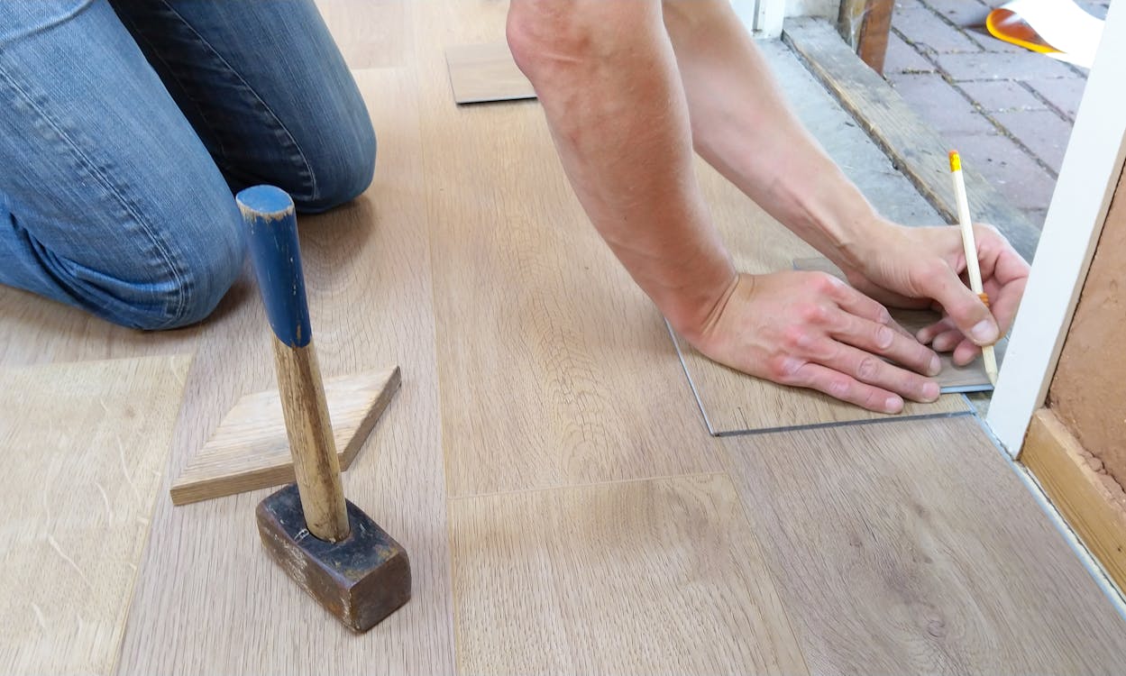 A person renovating a house’s floor for rent in Connecticut