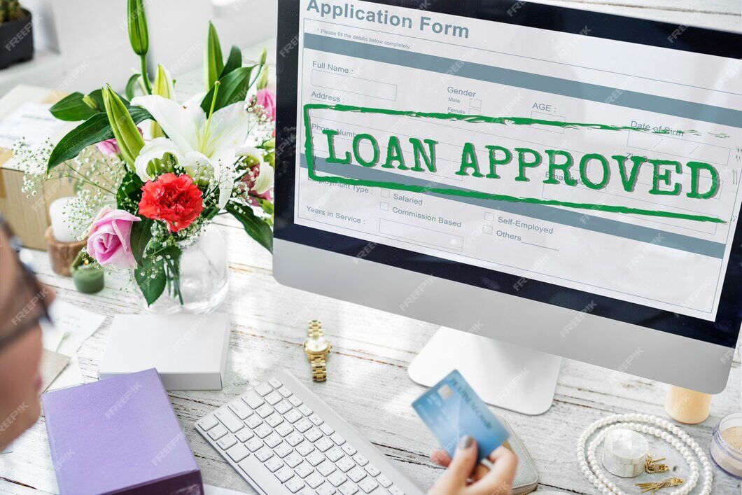 A computer screen displaying a "Loan Approved" message on an application form.