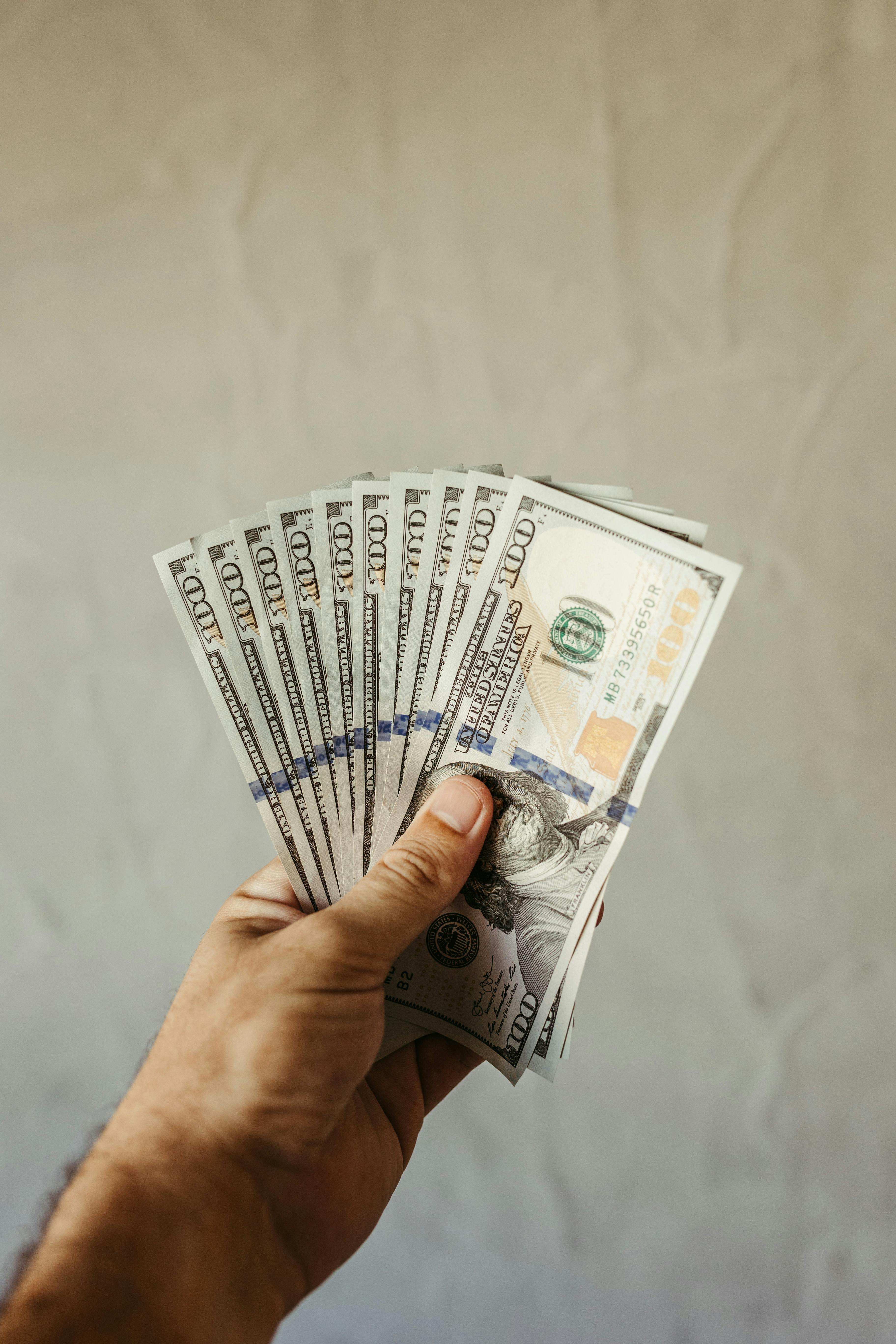 A person holding US dollars