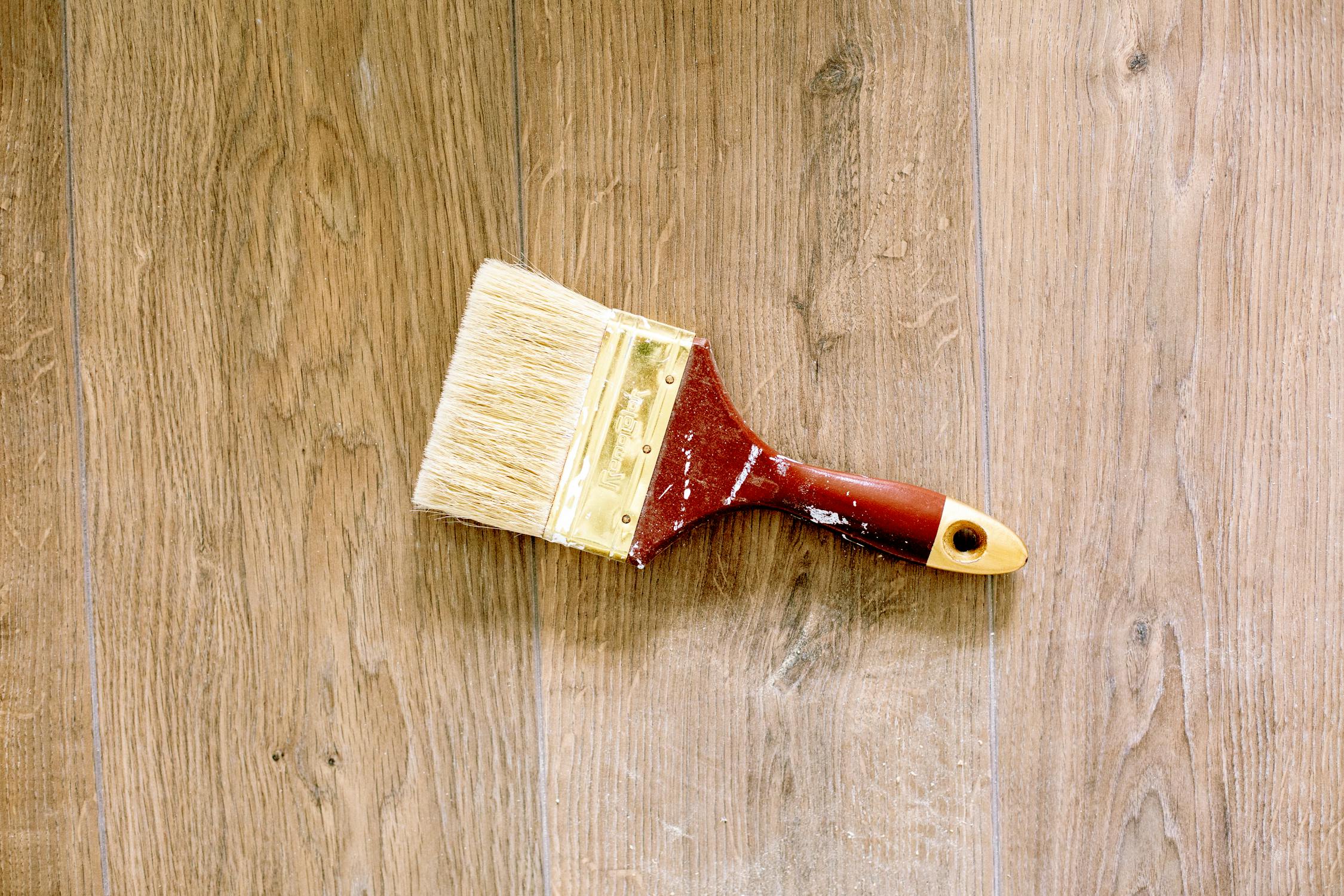 A paintbrush on a wooden floor