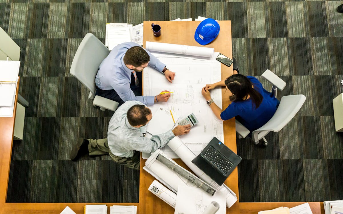 An image of people working in an office and looking over bridge loan documents