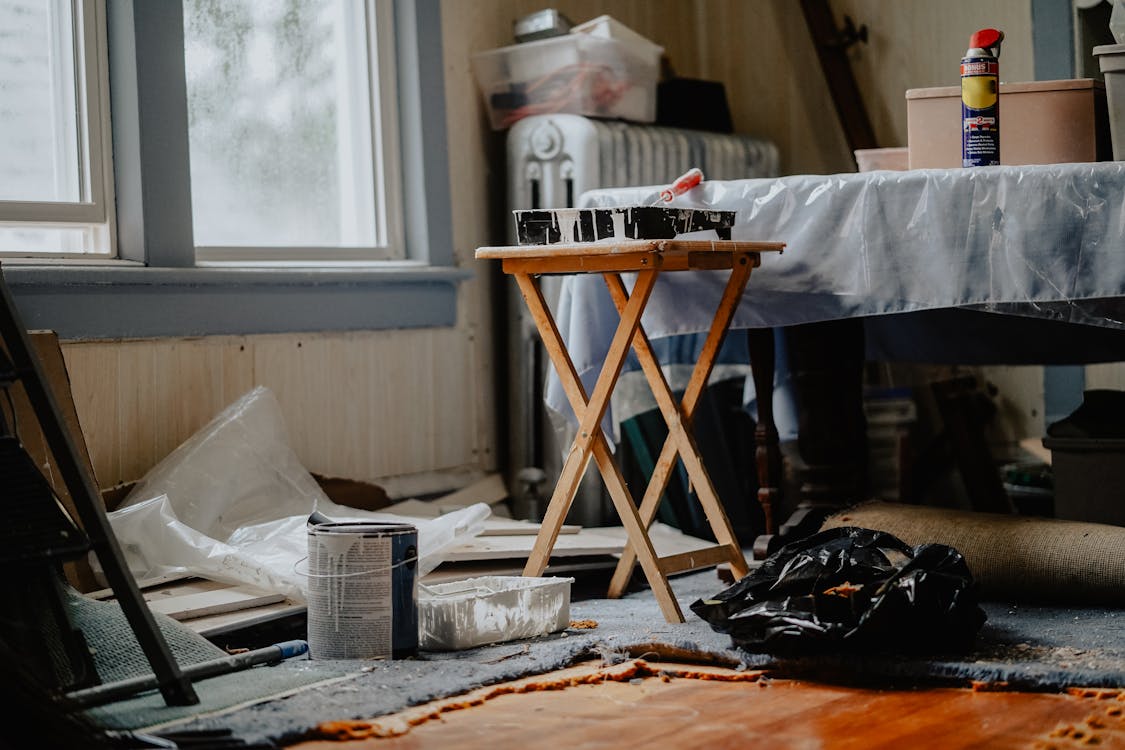 A room under renovation with paint containers, etc.