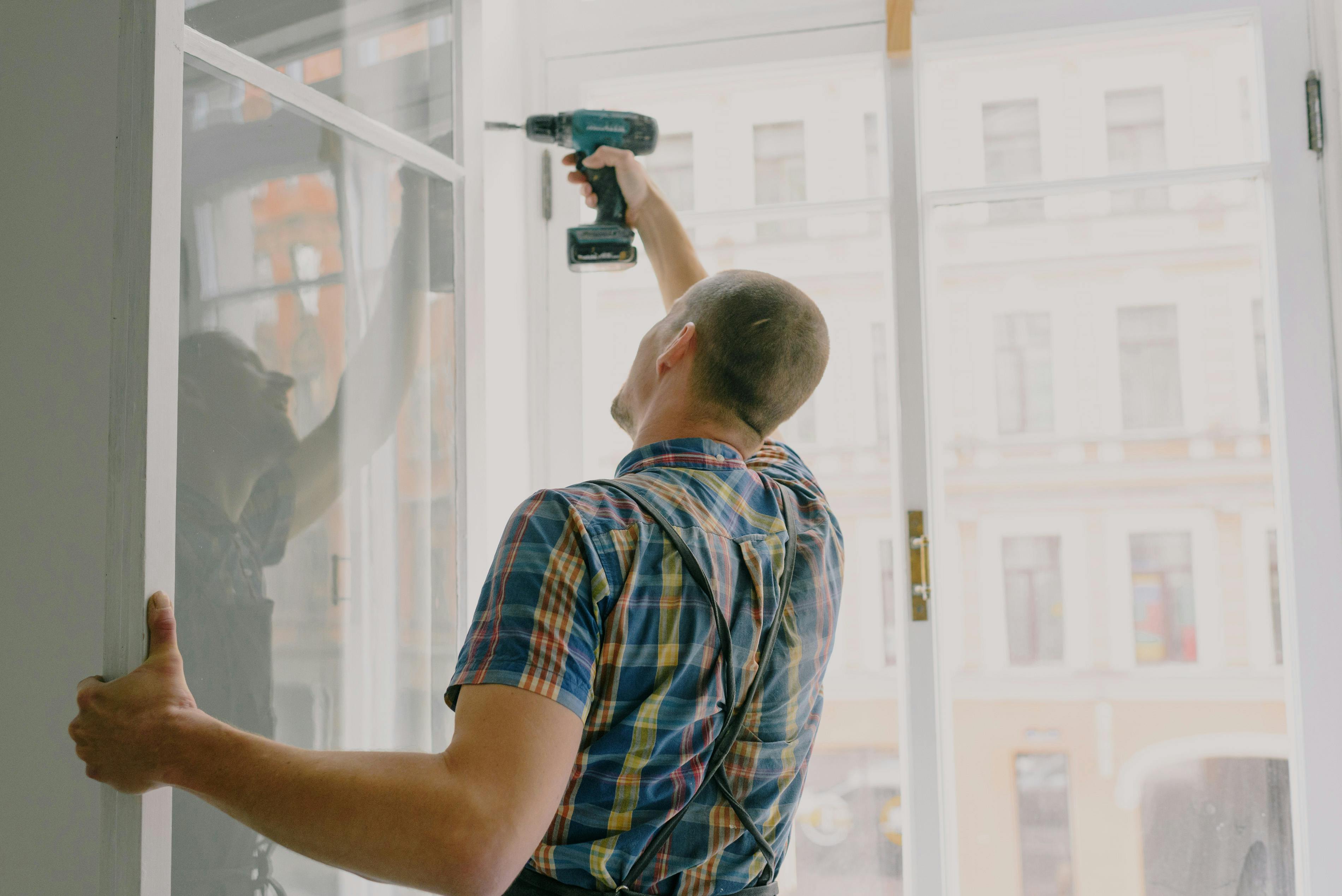 A man putting windows