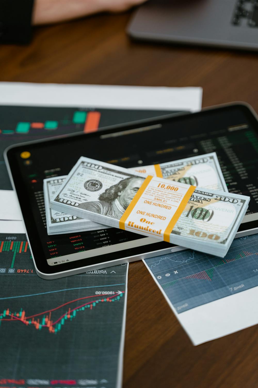 Bundles of 100-US dollar banknotes on a tablet