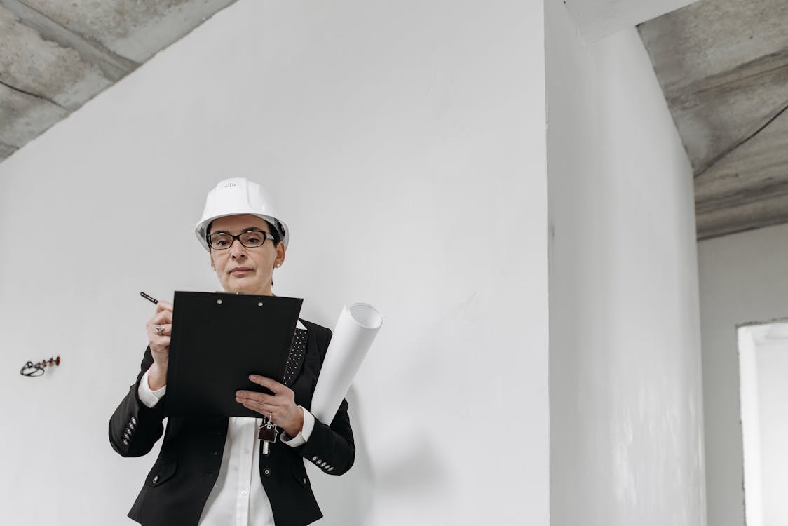 An image of a person wearing a white helmet and looking at a bridge loan file