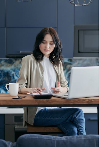 a businesswoman making timely bill payments on her laptop