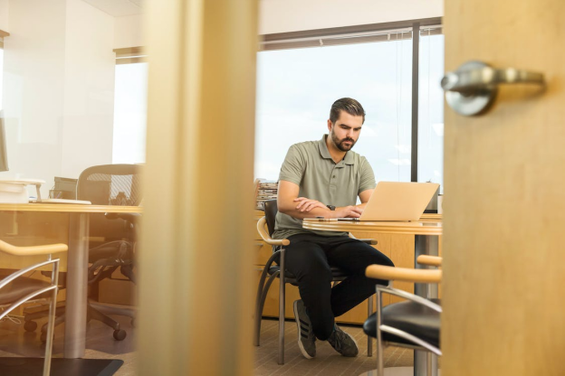 a real estate investor exploring debt repayment options on their laptop