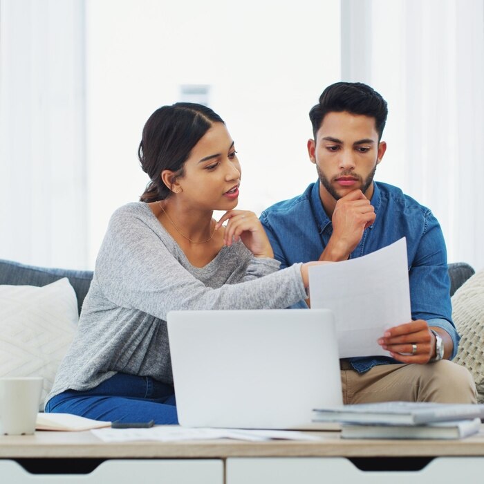 documents-laptop-planning-with-couple-sofa-living-room-home-bank-payment-computer-problem-solving-thinking-with-man-woman-apartment-review-accounting-insurance_590464-429180