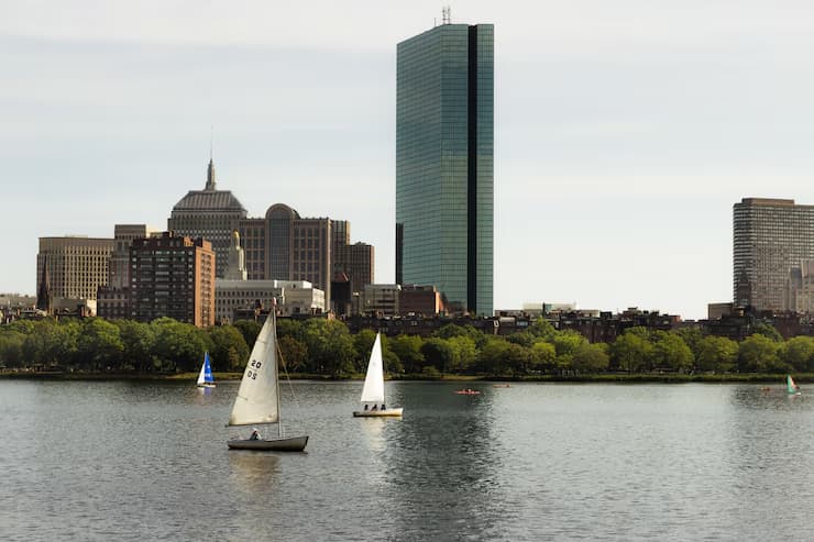 two-small-metal-boats-sailing-near-city-sunny-day_181624-3925