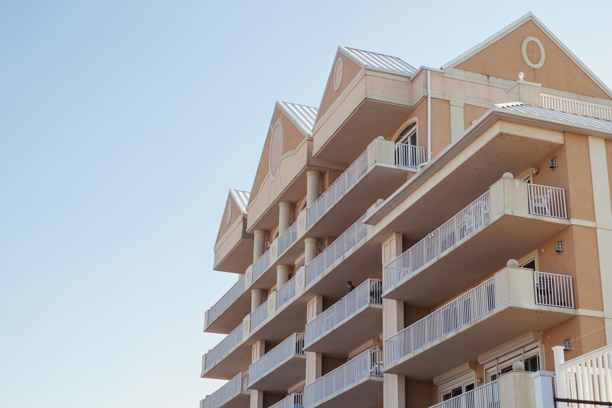 Modern multi-story apartment building with balconies.